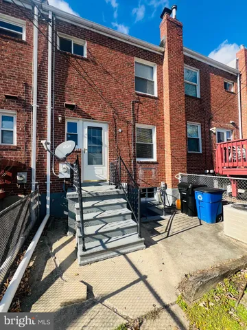 a view of a brick house with many windows