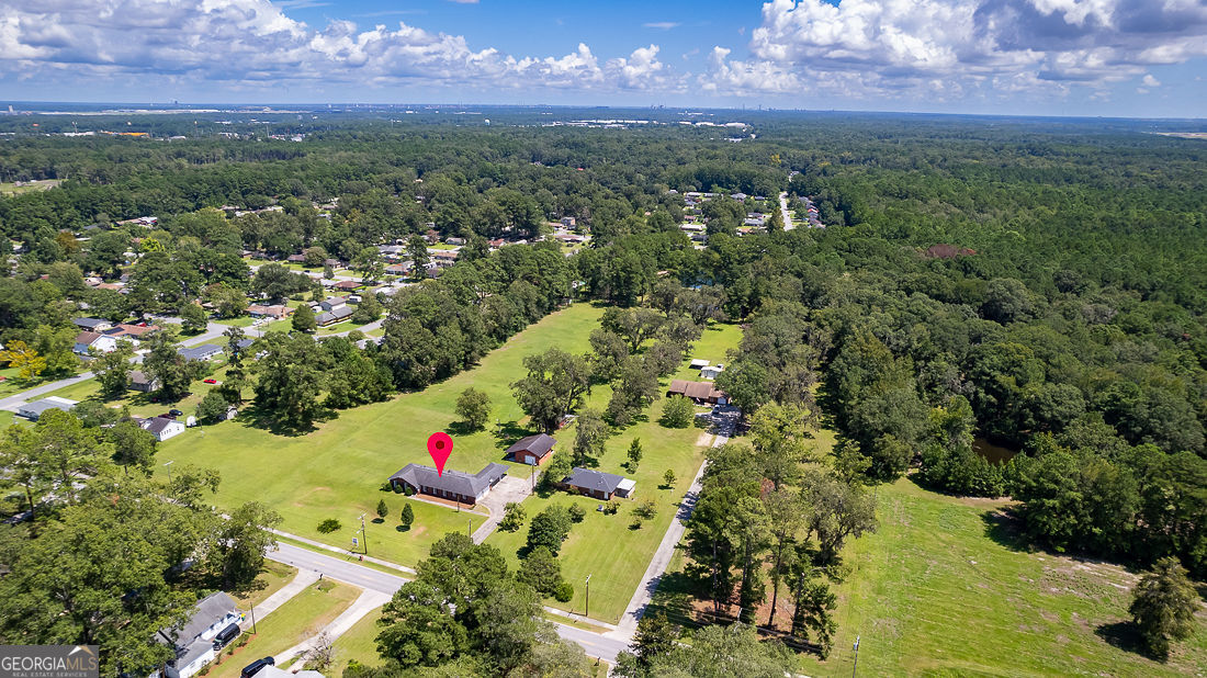 1324 South Rogers Street Pooler, GA 31322 - Photo 4 of 10 an aerial view of residential houses with outdoor space and trees