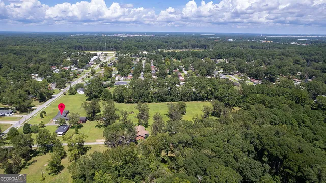 an aerial view of a houses with a yard