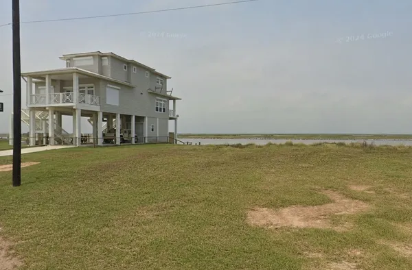 a front view of building with ocean