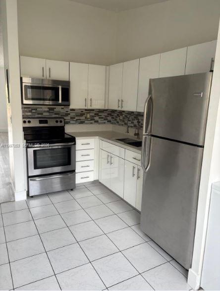 13447 Southwest 154th Street, Unit 2208 Miami, FL 33177 - Photo 3 of 11 a kitchen with stainless steel appliances a refrigerator sink and microwave