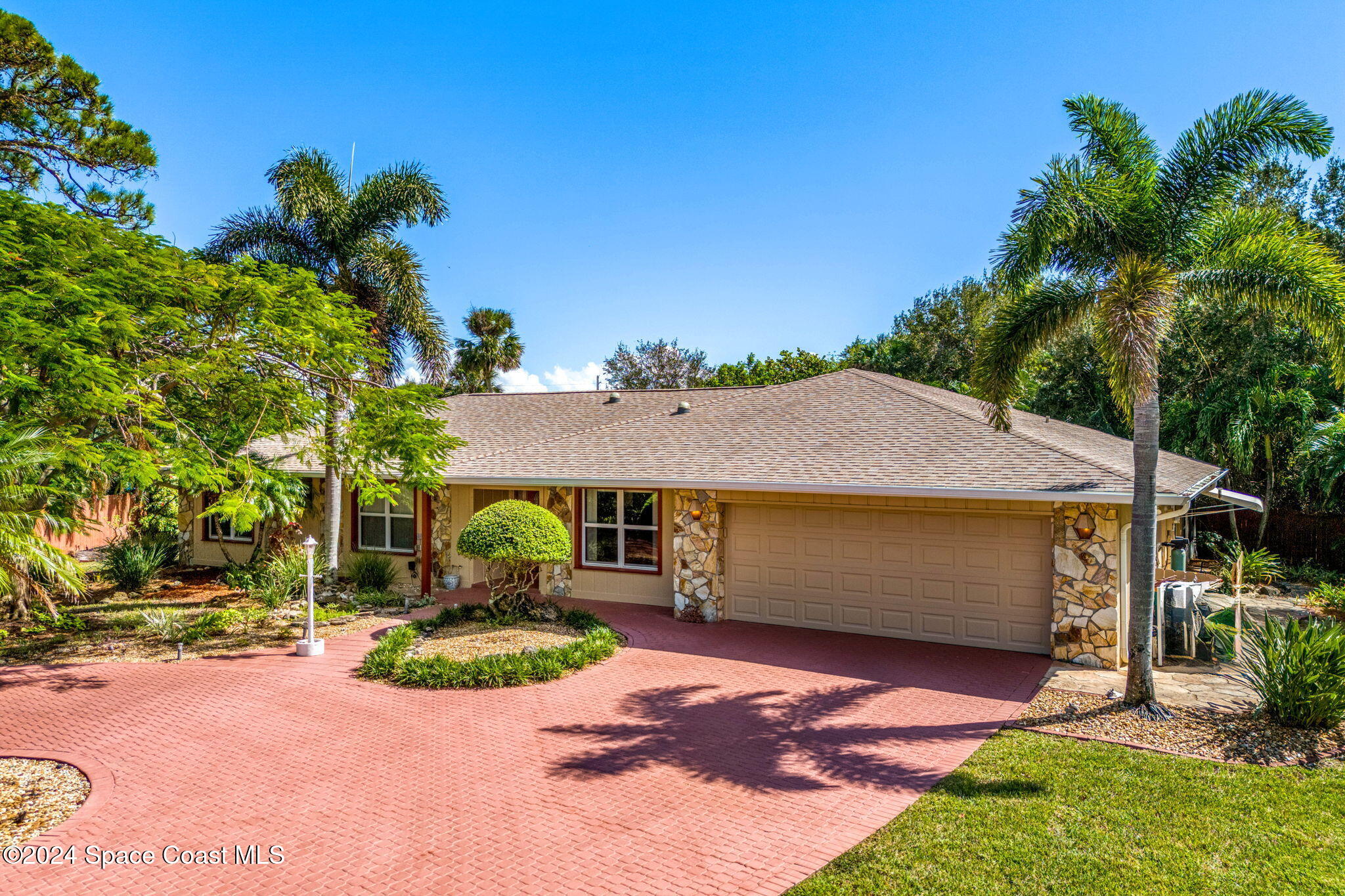 4 Colonial Way Indian Harbour Beach, FL 32937 - Photo 1 of 58 a aerial view of a house with table and chairs under an umbrella