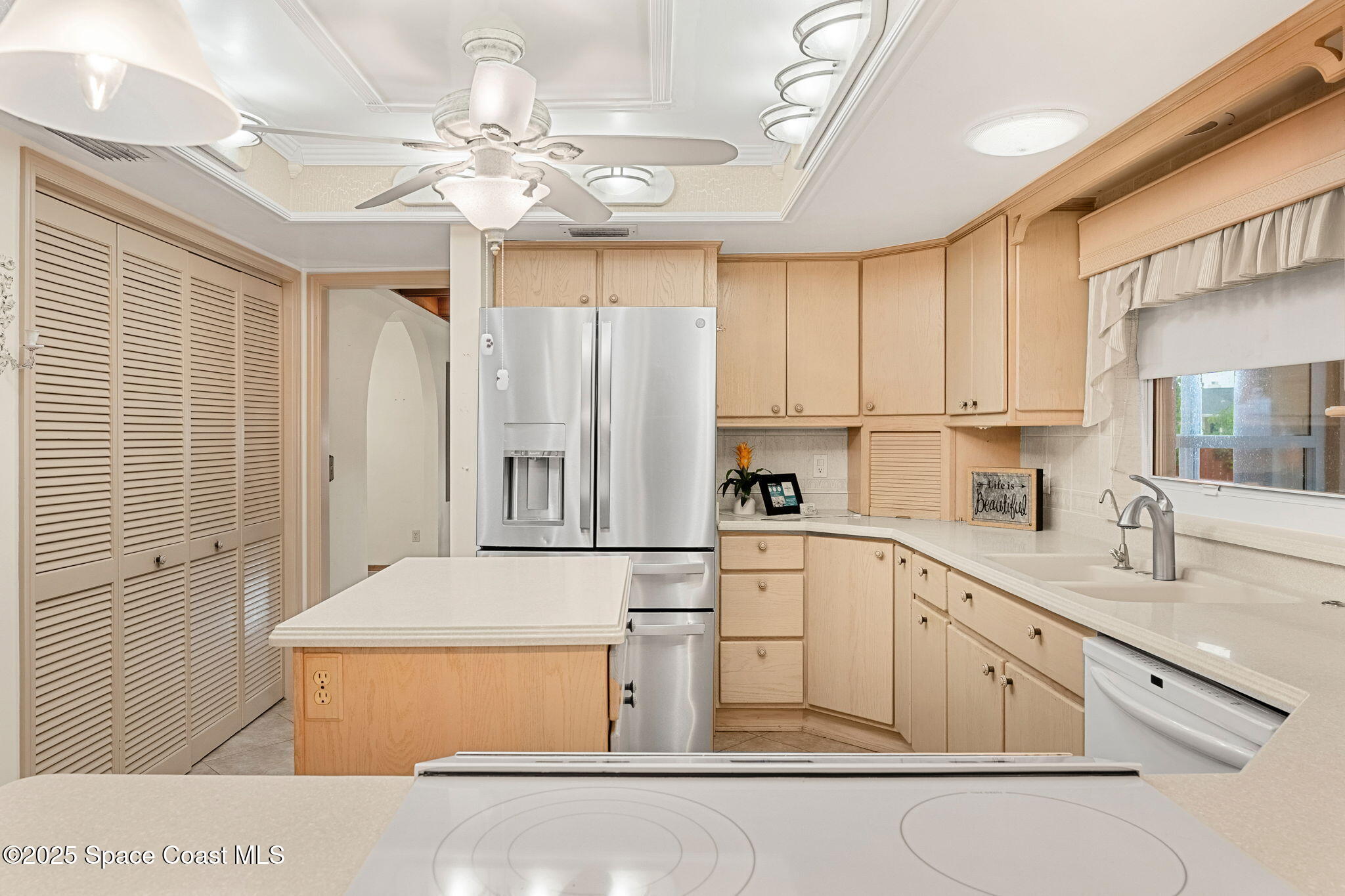 4 Colonial Way Indian Harbour Beach, FL 32937 - Photo 25 of 58 a kitchen with white cabinets and white appliances