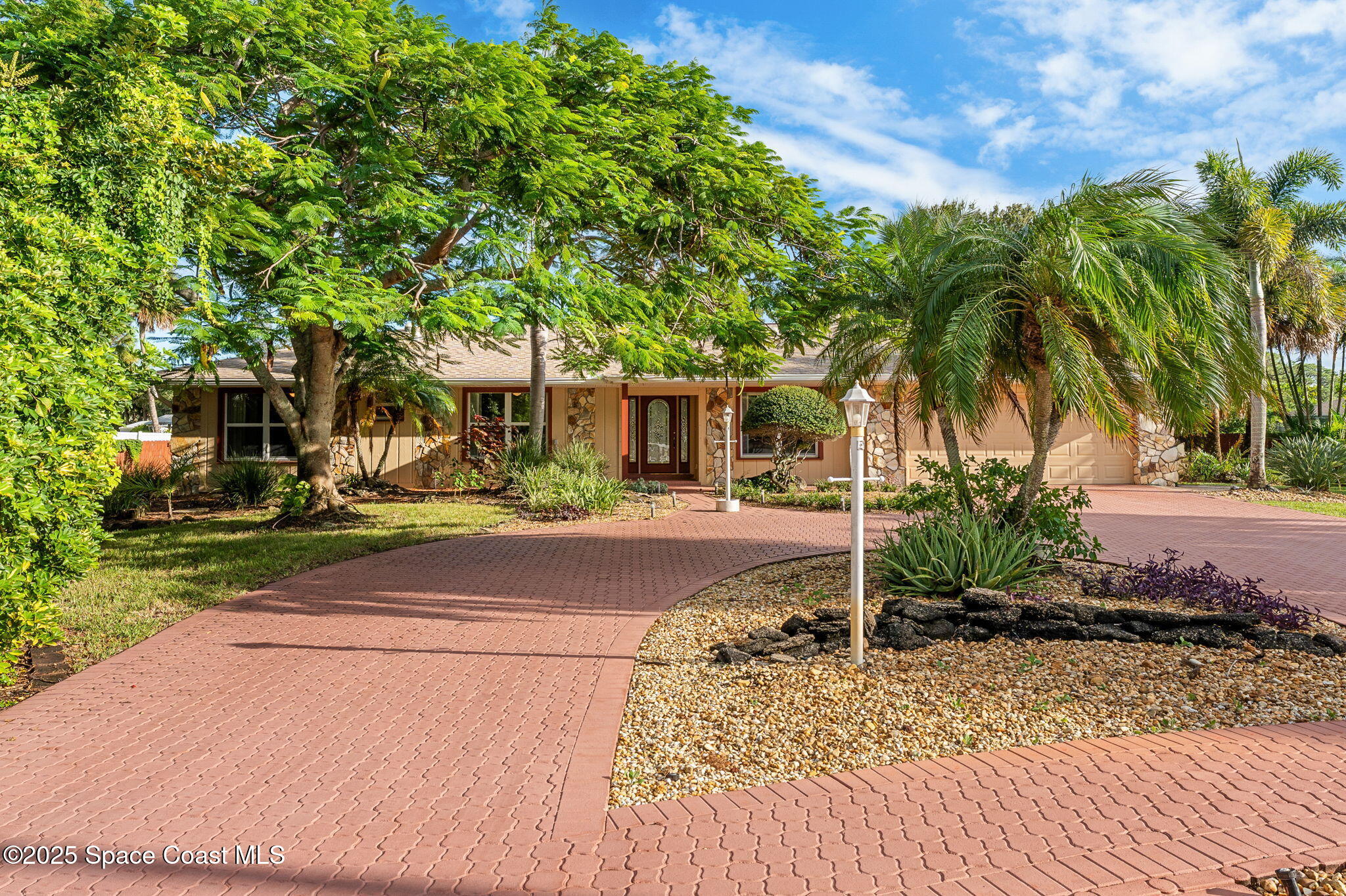 4 Colonial Way Indian Harbour Beach, FL 32937 - Photo 3 of 58 a view of a backyard with palm trees