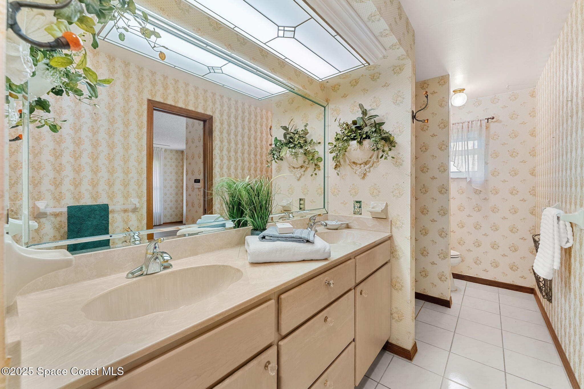 4 Colonial Way Indian Harbour Beach, FL 32937 - Photo 32 of 58 a bathroom with a sink and a mirror