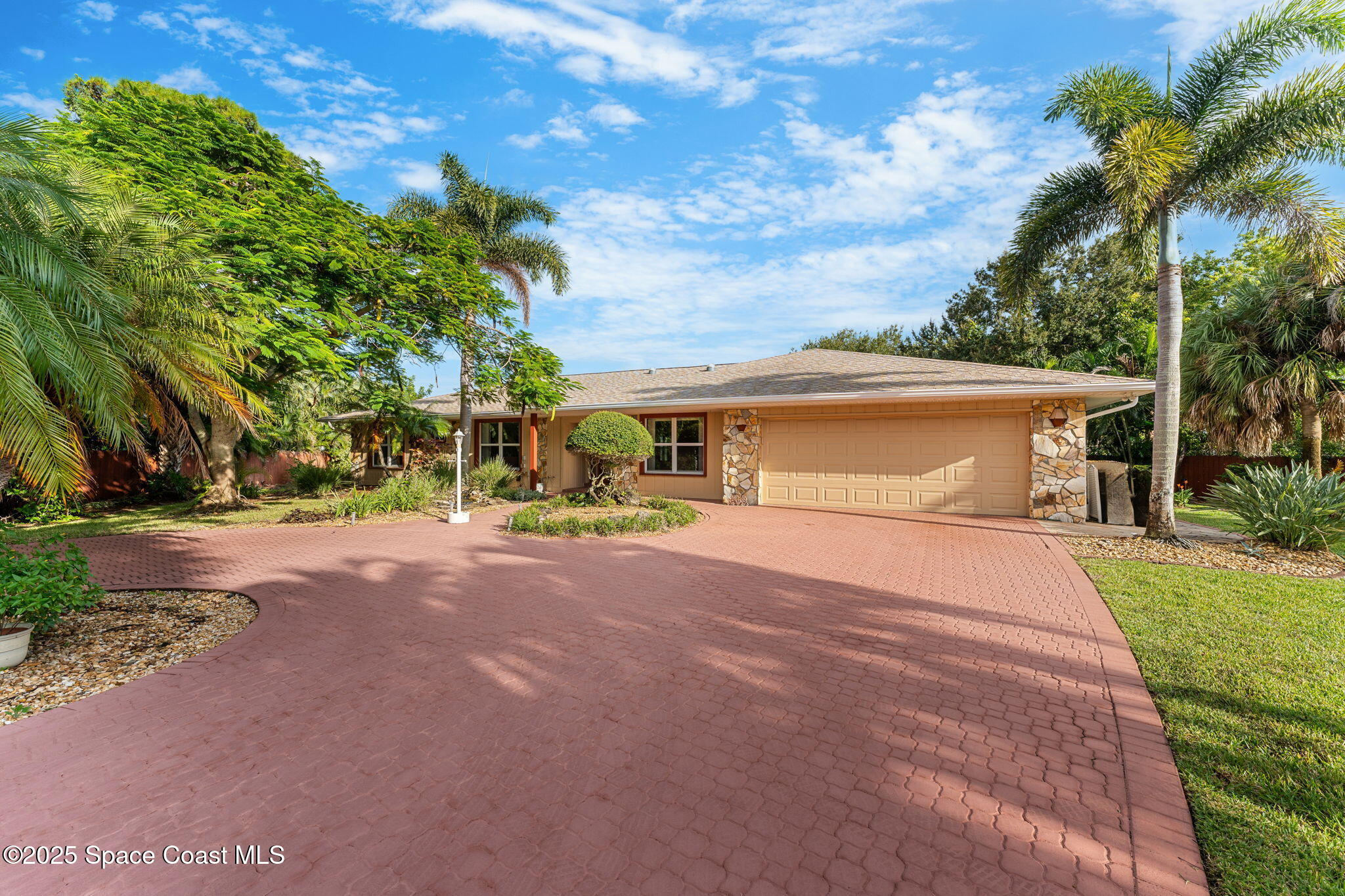 4 Colonial Way Indian Harbour Beach, FL 32937 - Photo 4 of 58 a front view of a house with a yard and garage