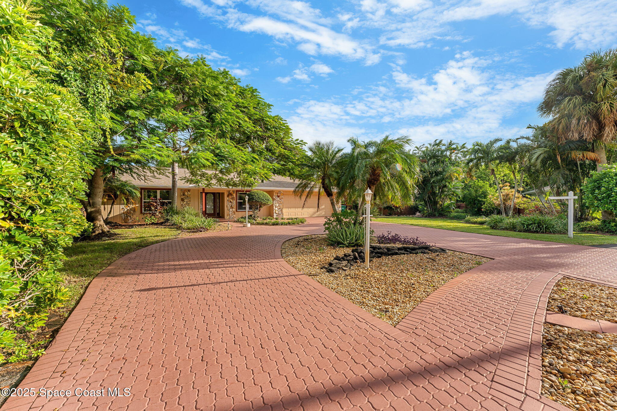 4 Colonial Way Indian Harbour Beach, FL 32937 - Photo 5 of 58 a front view of a house with a yard and trees