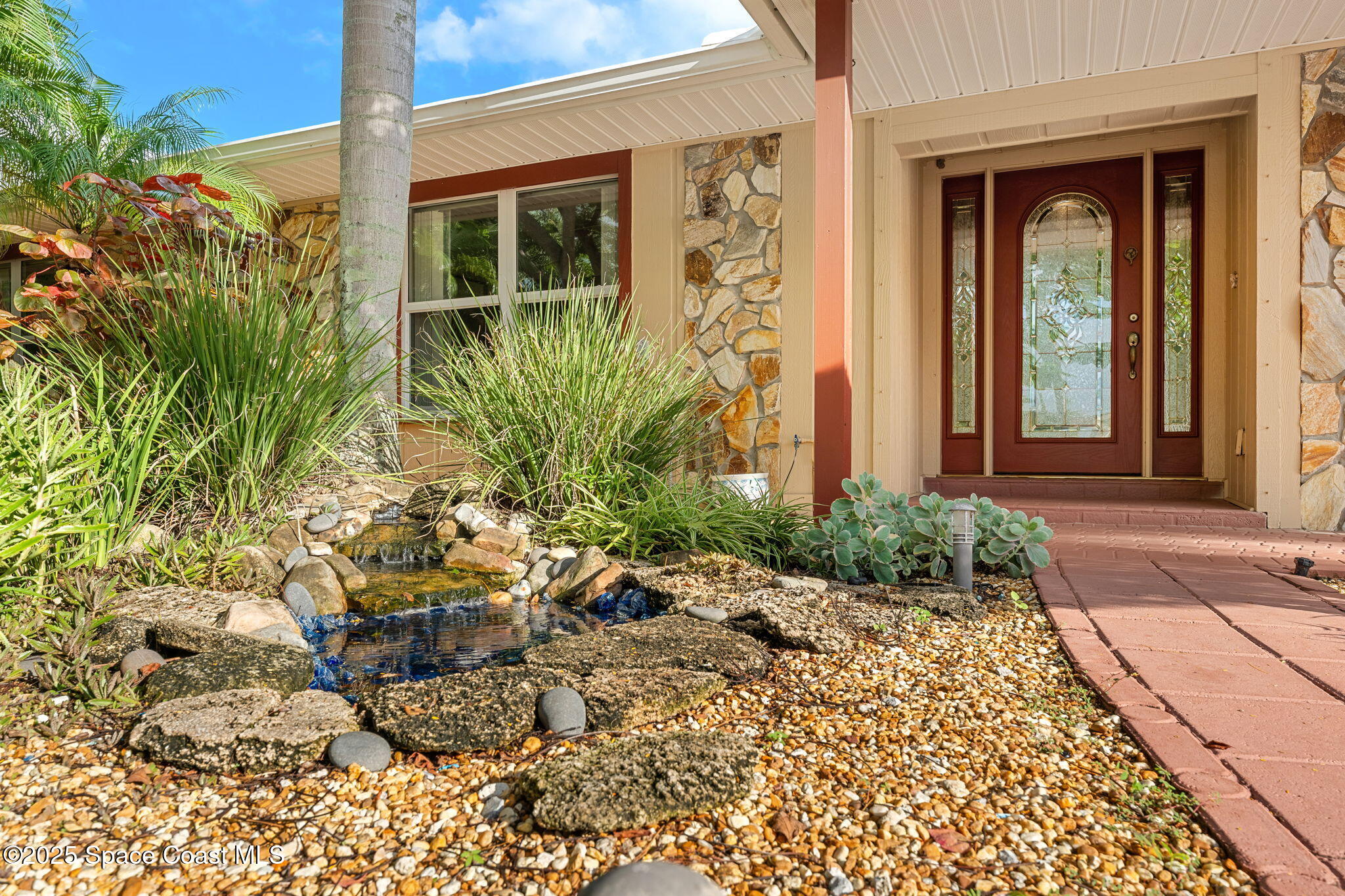 4 Colonial Way Indian Harbour Beach, FL 32937 - Photo 7 of 58 a view of a chair and table in front of house
