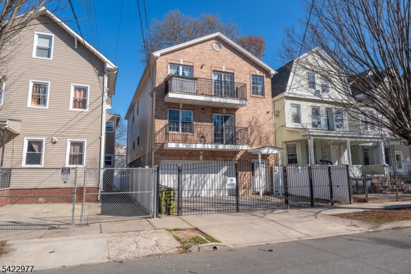 175 North 7th Street Newark, NJ 07107 - Photo 2 of 17 a front view of a house with a garage