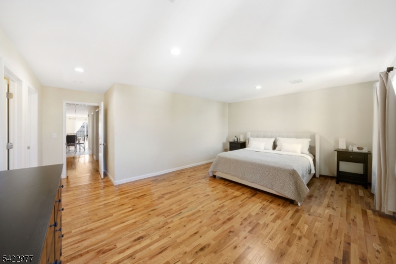 175 North 7th Street Newark, NJ 07107 - Photo 10 of 17 a bedroom with a bed and wooden floor