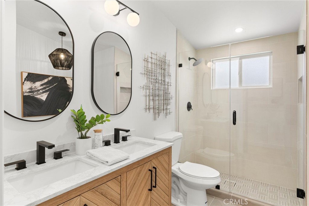 1709 Orcas Drive Costa Mesa, CA 92626 - Photo 13 of 25 a bathroom with a toilet sink and mirror