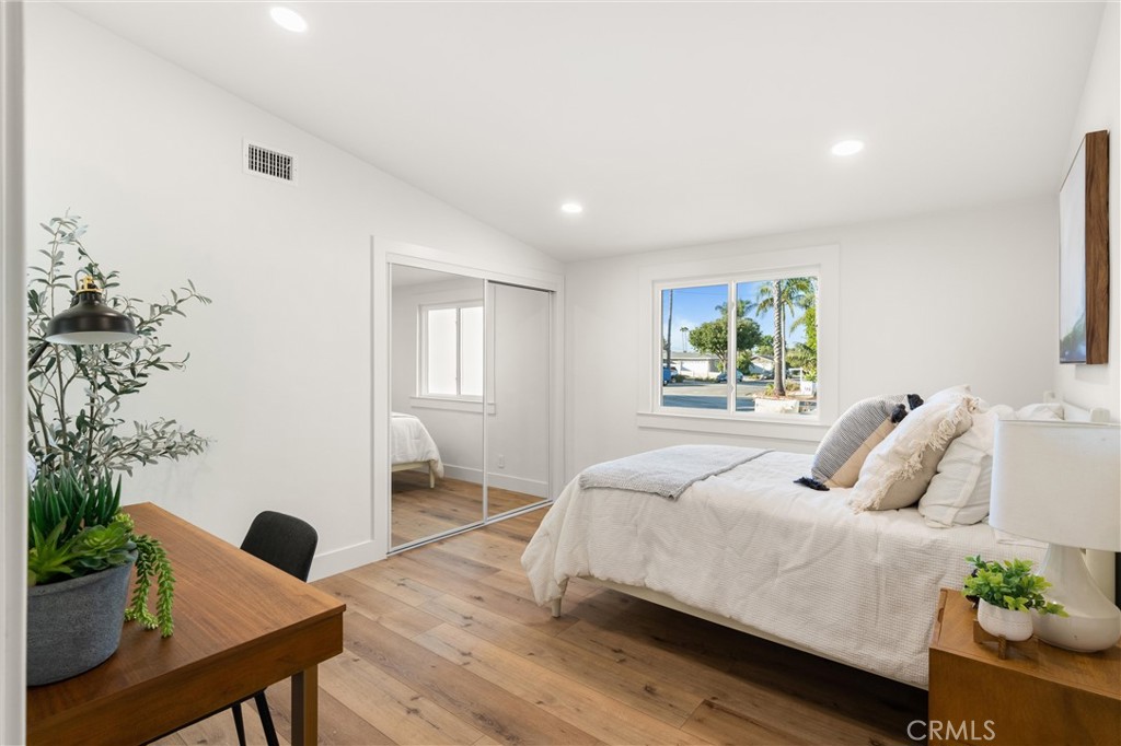 1709 Orcas Drive Costa Mesa, CA 92626 - Photo 19 of 25 a bedroom with a large bed and a potted plant