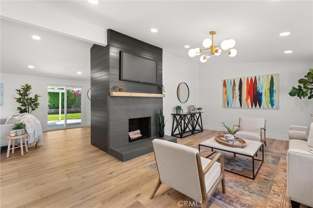 1709 Orcas Drive Costa Mesa, CA 92626 - Photo 2 of 25 a living room with fireplace furniture and a wooden floor