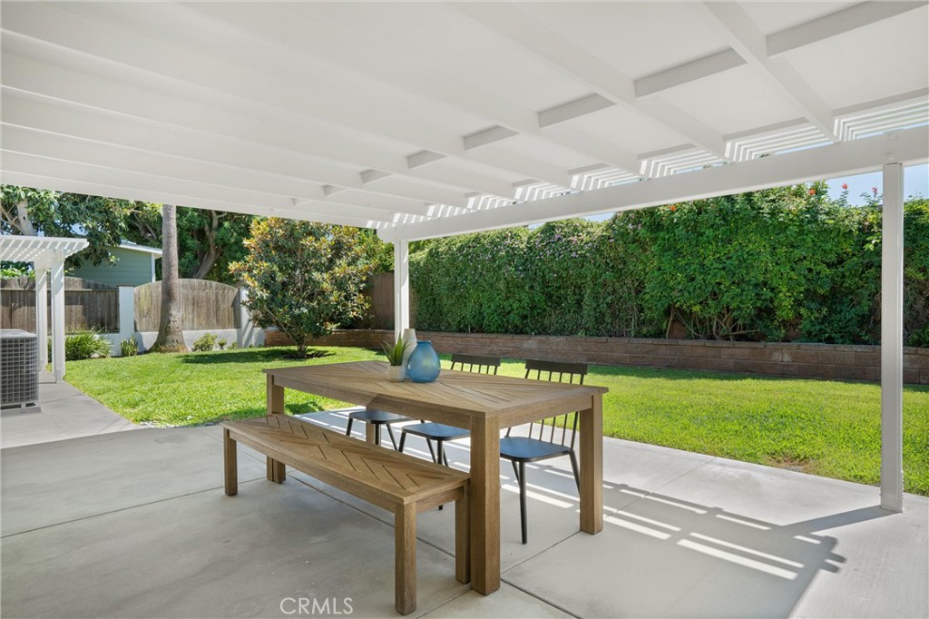 1709 Orcas Drive Costa Mesa, CA 92626 - Photo 21 of 25 a view of a patio with a table chairs and a backyard