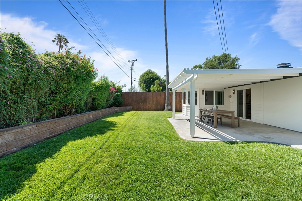 1709 Orcas Drive Costa Mesa, CA 92626 - Photo 23 of 25 a view of a backyard with table and chairs under an umbrella