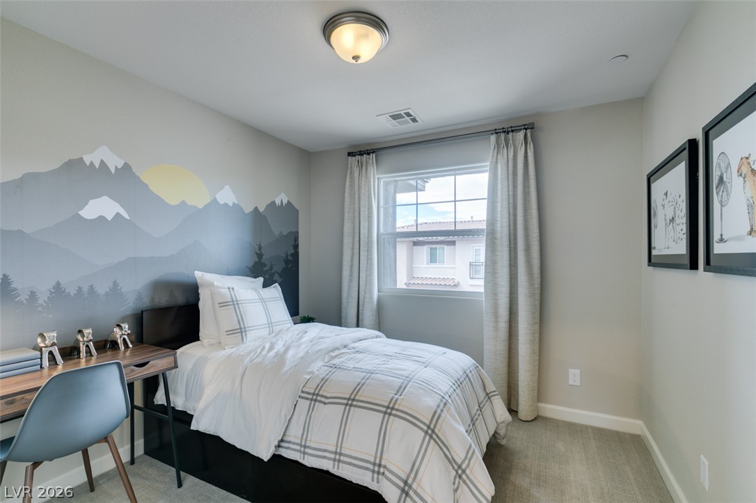 653 Pickled Pepper Place Henderson, NV 89011 - Photo 21 of 35 A well-lit bedroom with a vibrant mural and ample natural illumination from a large window.