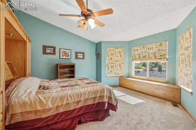 a bedroom with a large bed and a large window