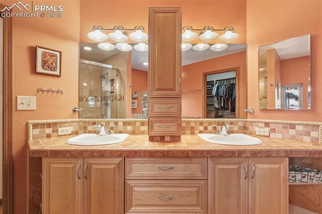 a bathroom with a sink vanity and mirror