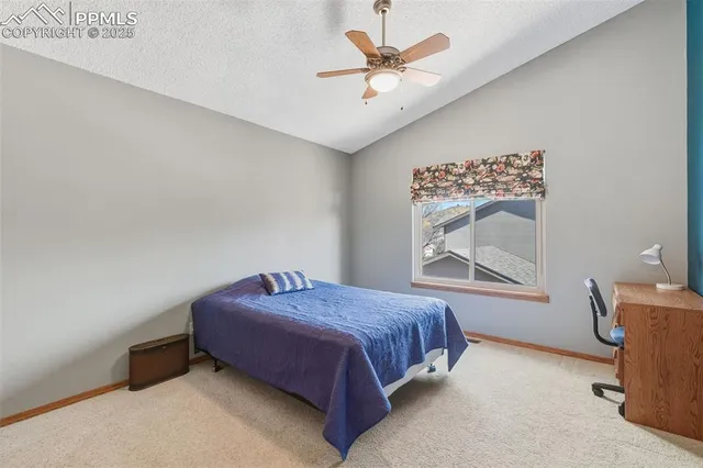 a spacious bedroom with a bed and a table in it