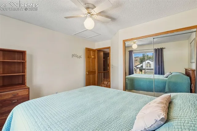 a bedroom with a large bed and a chandelier