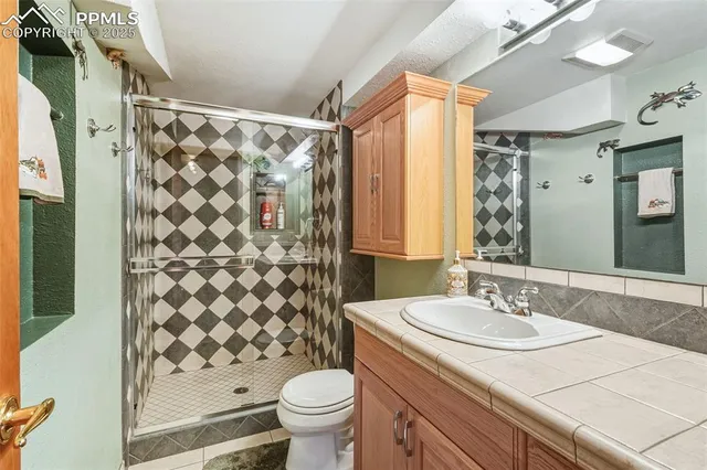 a bathroom with a sink toilet and shower