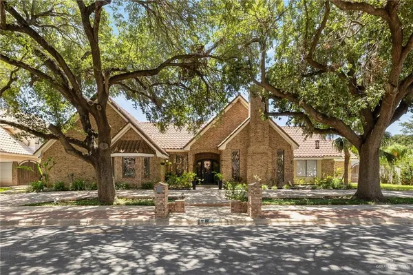 a front view of a house with a tree