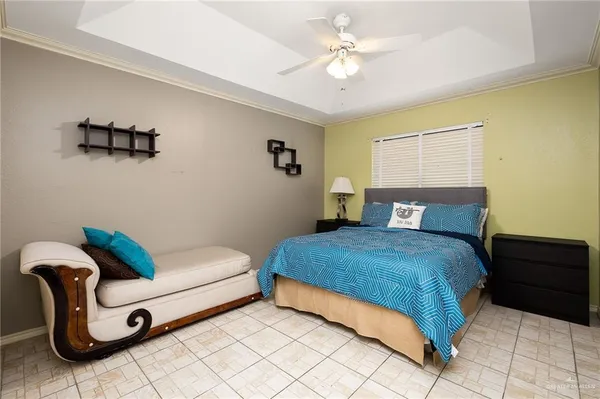 a bedroom with a bed and a couch