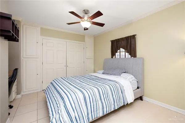 a bedroom with a bed and a painting on the wall