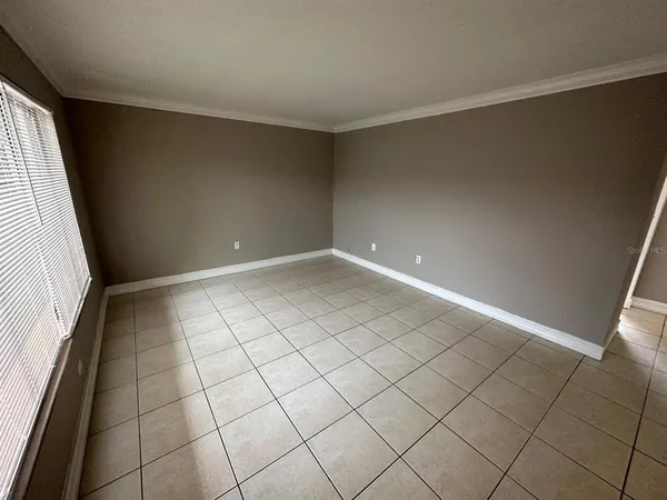 a view of an empty room and a window