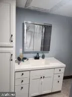 a view of water heater room with wooden floor