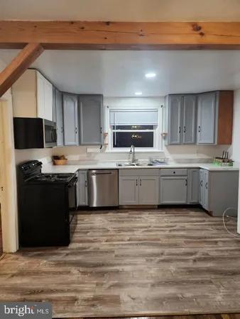 a view of kitchen and empty room