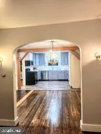 a view of a livingroom with a furniture wooden floor and chandelier