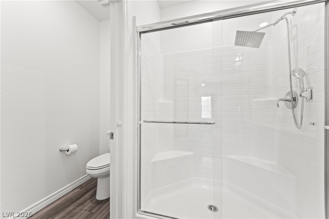 7204 North Decatur Boulevard, Unit 5 North Las Vegas, NV 89084 - Photo 12 of 34 Crisp subway tile lines the spacious walk-in shower featuring a modern rain showerhead.