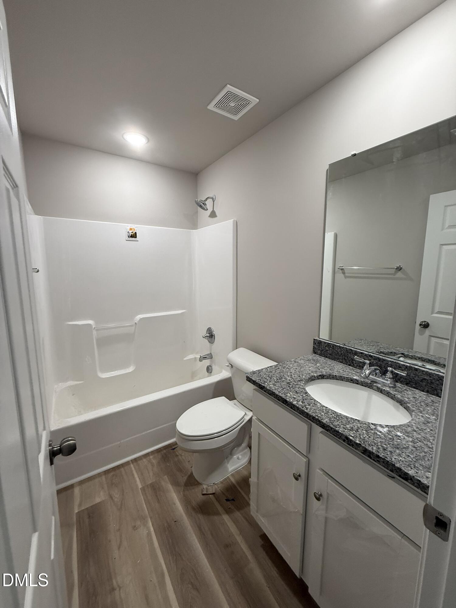 1843 Old Kenly Road Kenly, NC 27542 - Photo 14 of 16 a bathroom with a granite countertop sink toilet and shower
