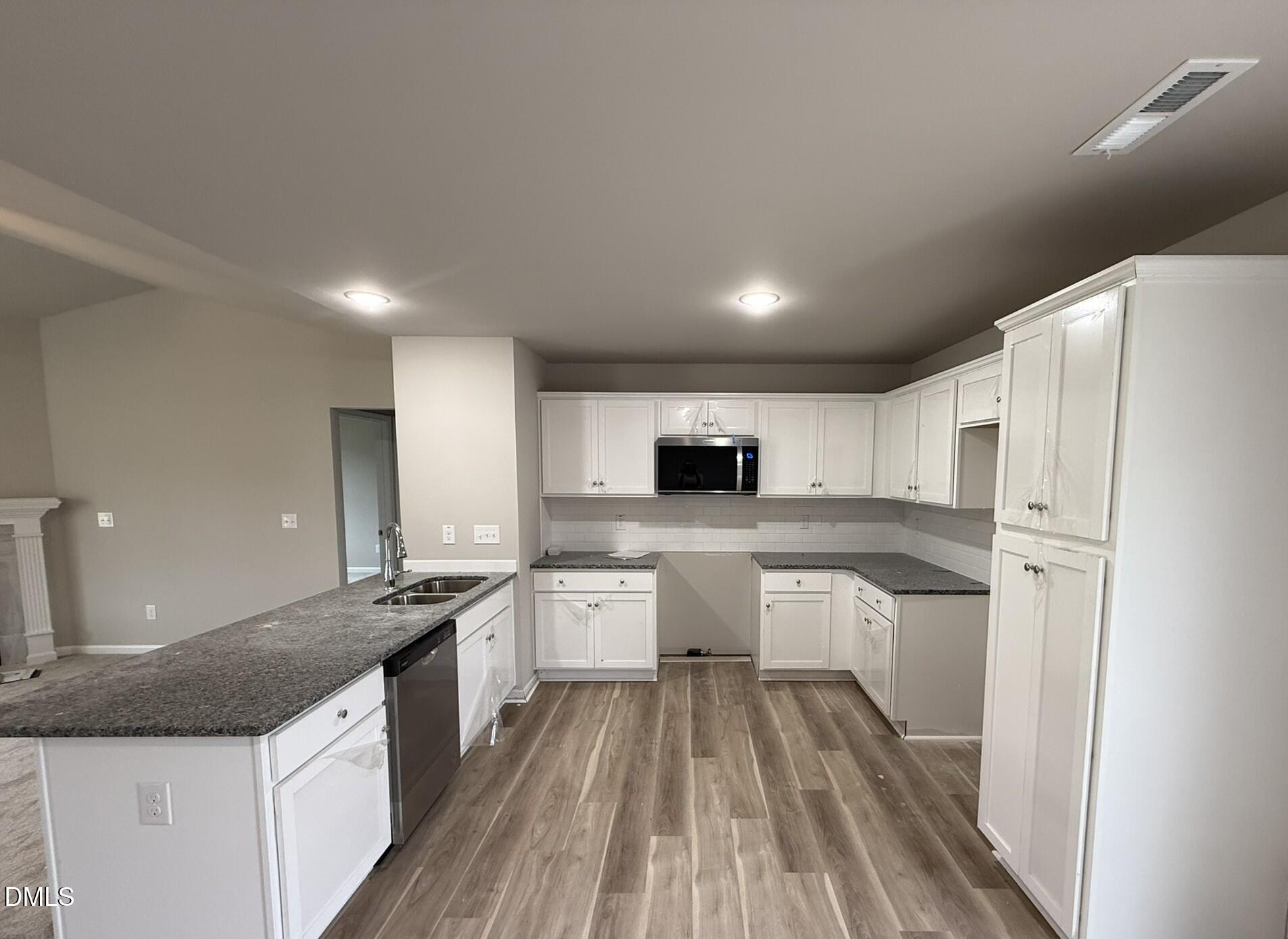 1843 Old Kenly Road Kenly, NC 27542 - Photo 7 of 16 a kitchen with stainless steel appliances granite countertop a sink stove and refrigerator