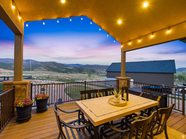 402 Shadow Hill Road Wanship, UT 84017 - Photo 2 of 90 Deck at dusk featuring outdoor dining space and a mountain view