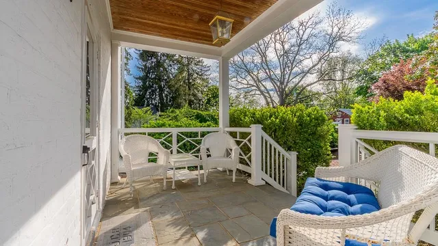 a kitchen with stainless steel appliances a white table chairs and a refrigerator