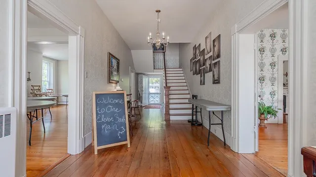 a view of a dining room with furniture and a chandelier