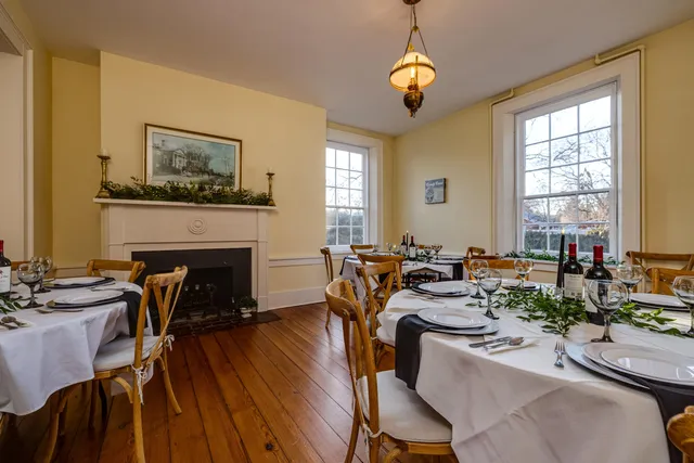 a living room with furniture a wooden floor and a large window