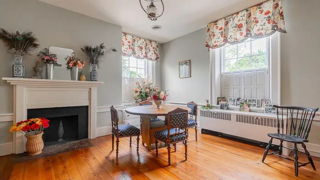 a view of hallway with furniture and wooden floor