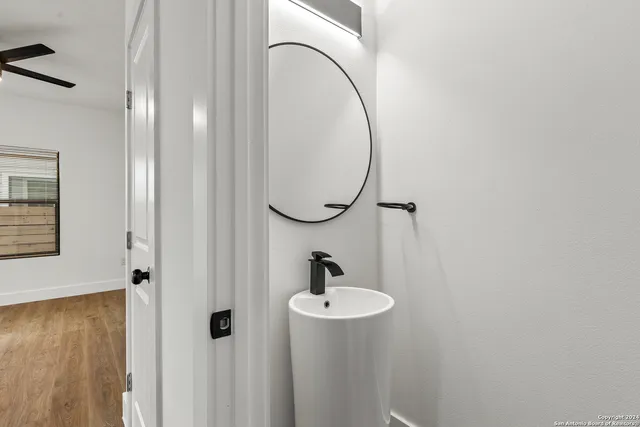 a bathroom with a sink a mirror and a shower