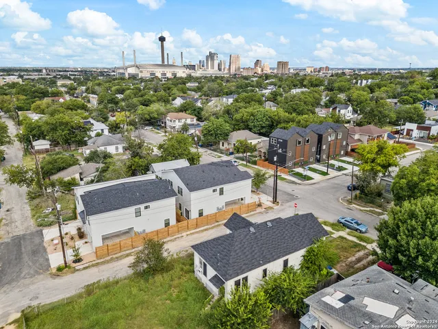 an aerial view of a house with a yard and lake view