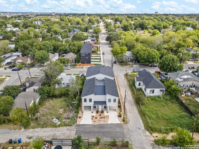 an aerial view of residential houses with outdoor space