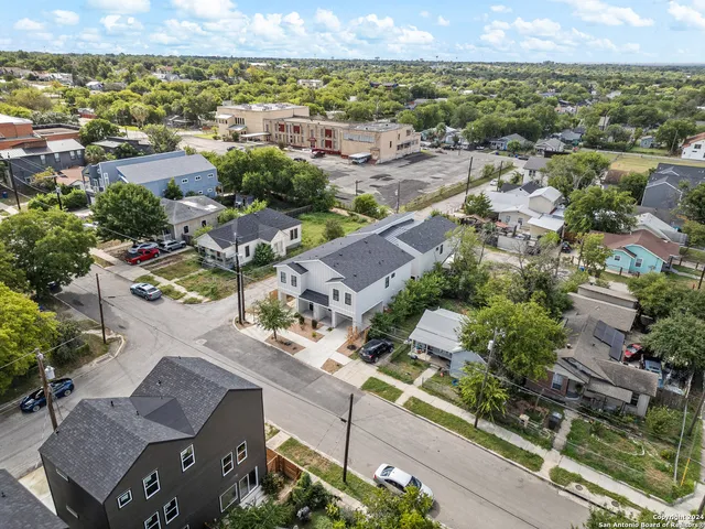 an aerial view of residential houses with outdoor space