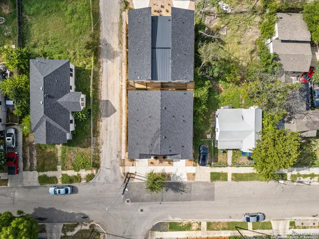 an aerial view of a house with a swimming pool