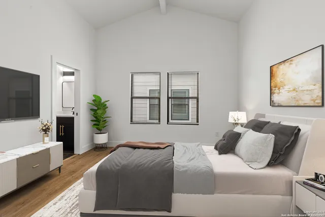 a bedroom with a bed and a flat screen tv