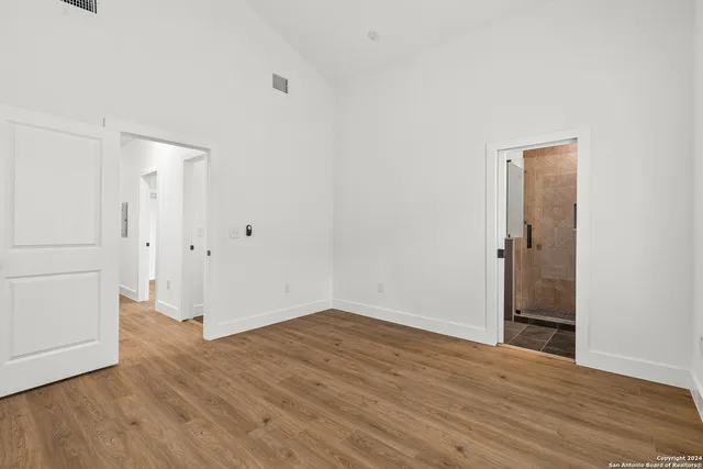 an empty room with wooden floor