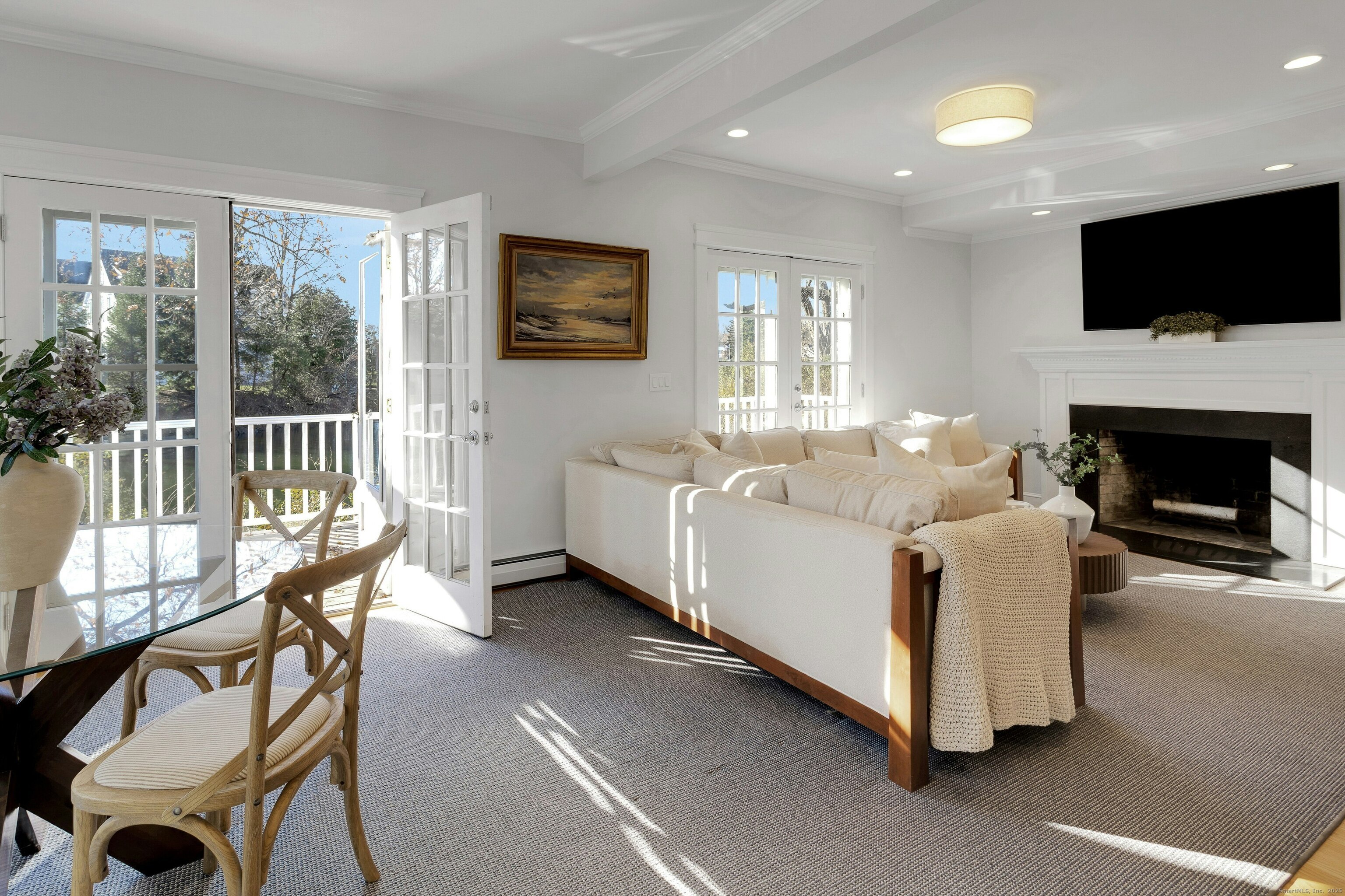 209 Rowayton Avenue Norwalk, CT 06853 - Photo 15 of 26 a living room with furniture a flat screen tv and a fireplace