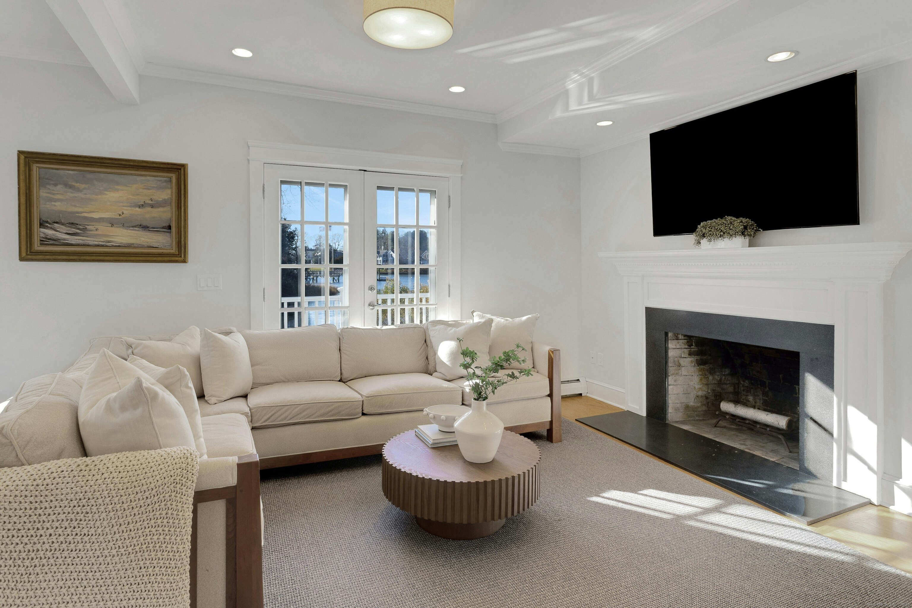 209 Rowayton Avenue Norwalk, CT 06853 - Photo 16 of 26 a living room with a fireplace and a flat screen tv