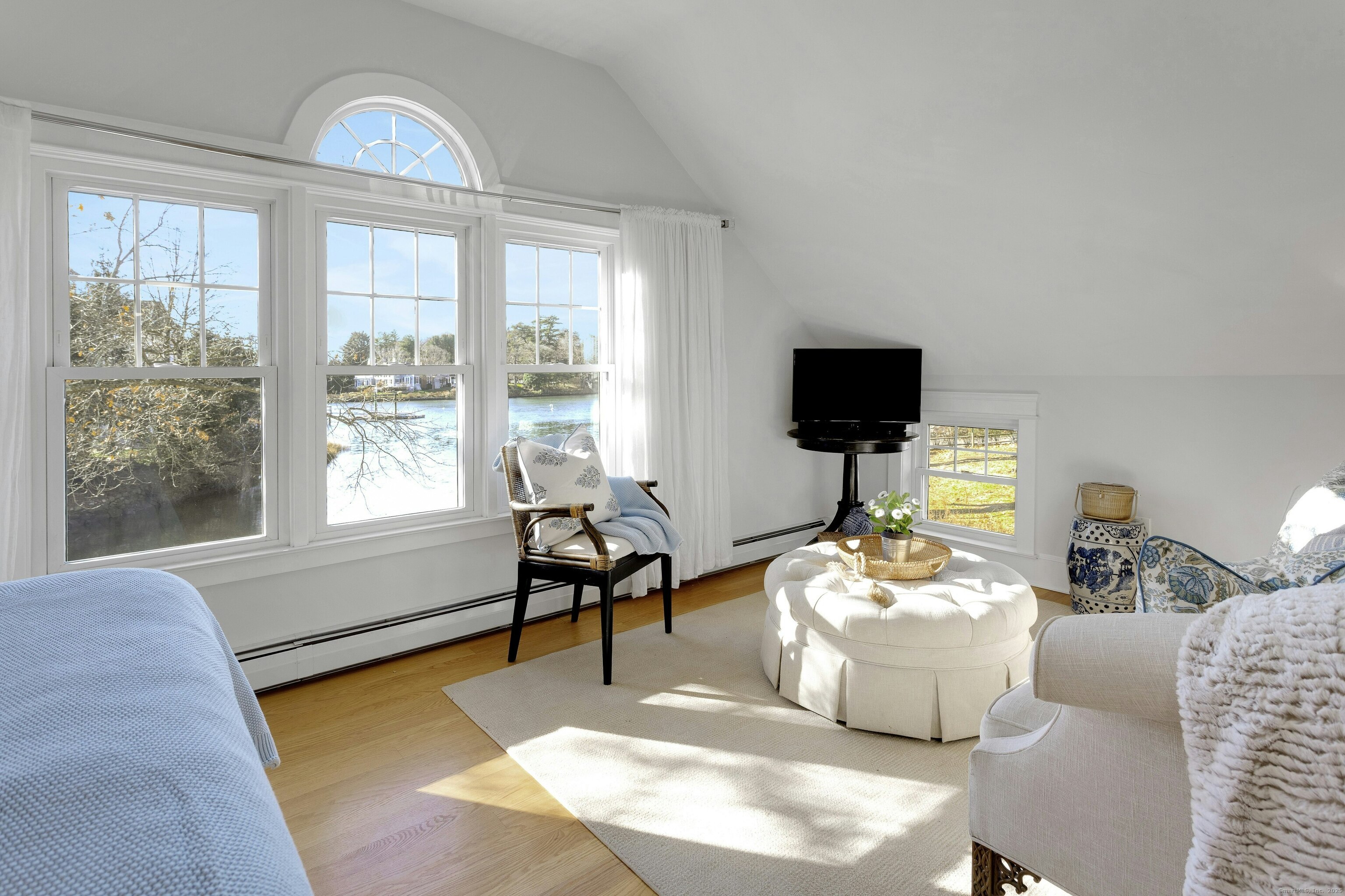 209 Rowayton Avenue Norwalk, CT 06853 - Photo 20 of 26 a living room with furniture a flat screen tv and a floor to ceiling window